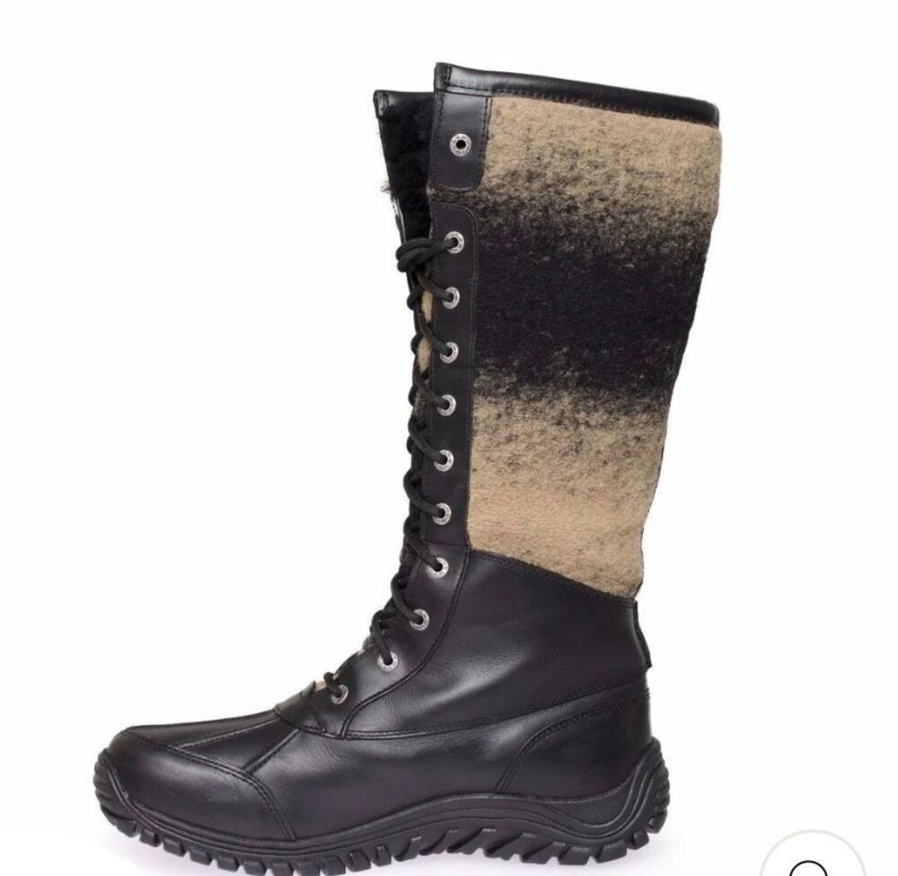 UGG Adirondack Tall boots, featuring black leather lowers and a cozy tan-and-bla